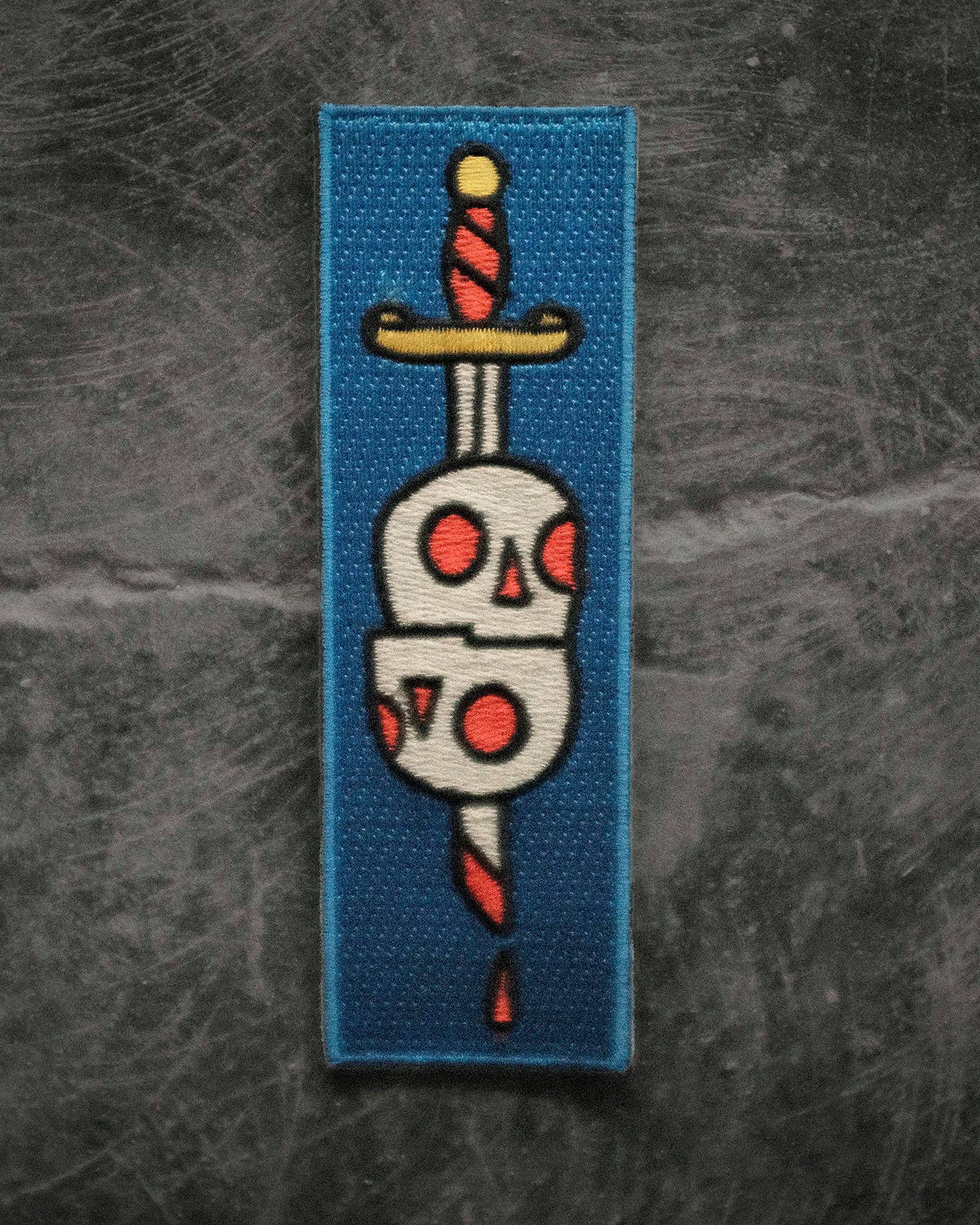 SWORD AND SKULLS BADGE